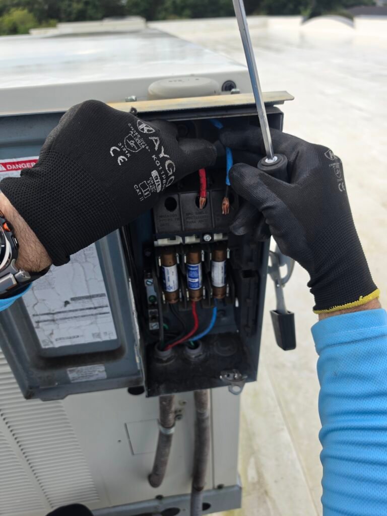 Technician adjusting wires in HVAC unit, Riverview, FL 33579