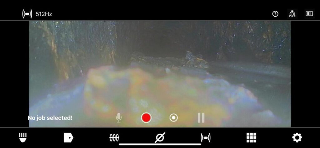 camera inspection of a pipe showing debris and buildup likely related to plumbing services provided by home therapist cooling heating and plumbing