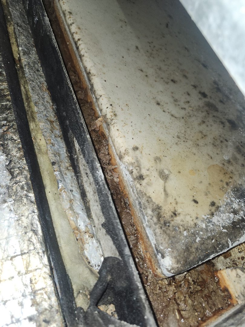 Cleaning A Dirty Air Conditioner Unit Showing Dust Grime And Debris Buildup Around The Coils And Components