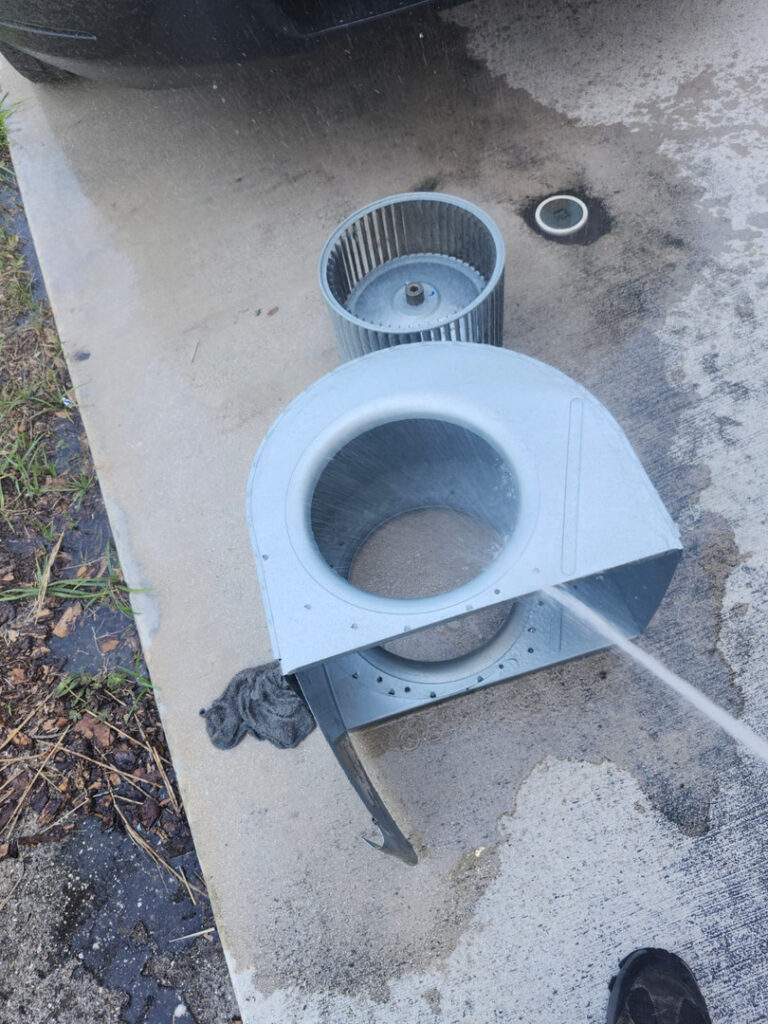 Cleaning Metal Components Likely Related To Heating Or Cooling Systems Water Is Being Sprayed On The Parts