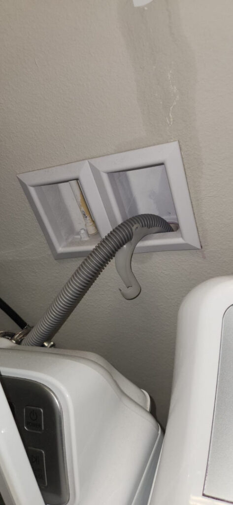 drying system being installed with hoses connected to wall vents for moisture removal and air circulation in a home