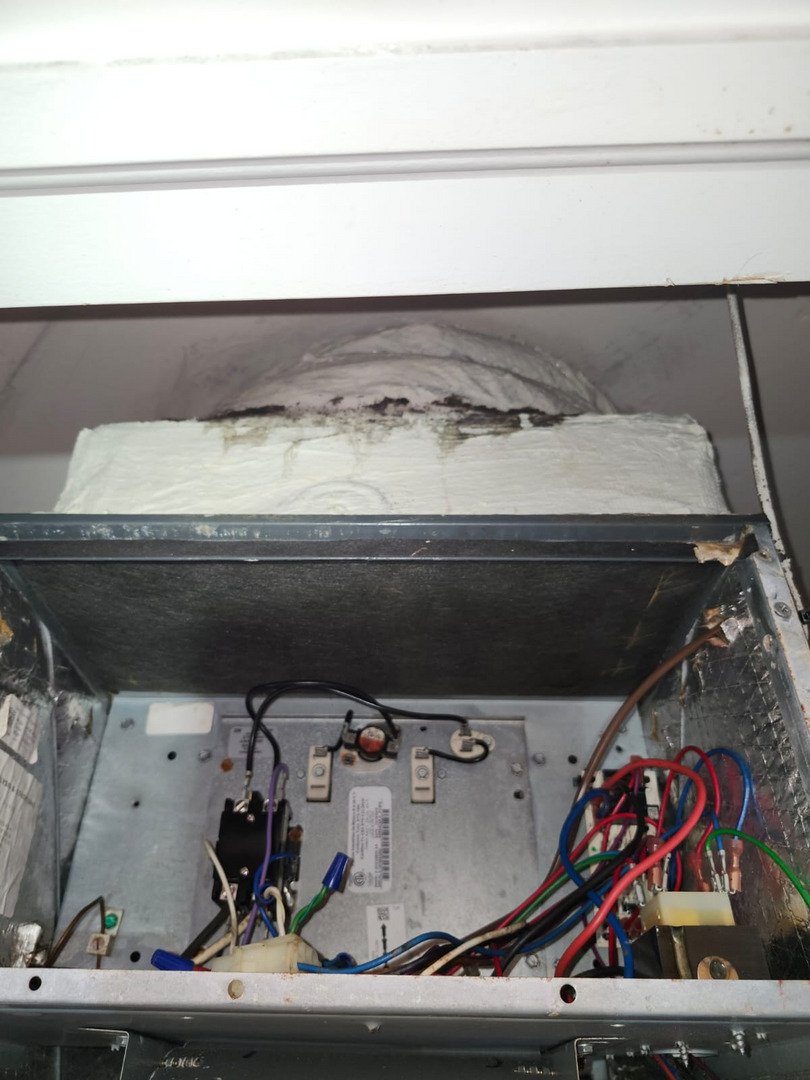 electric panel with visible wiring connections inside an HVAC unit potentially indicating maintenance or repair work being performed