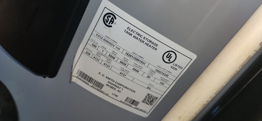 electric storage tank water heater manufacturer label with specifications and model information visible on the exterior of the tank