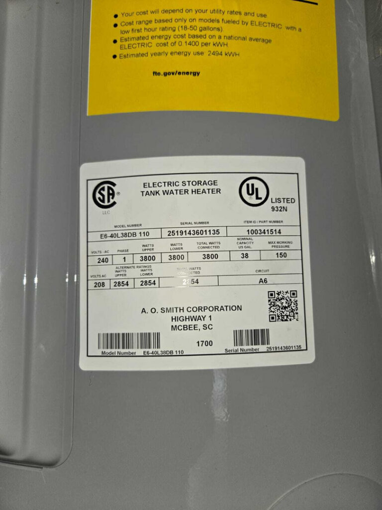 electric storage tank water heater with specifications and energy usage details attached to the unit