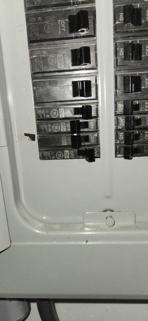 electrical panel with multiple circuit breakers in the off position some are turned on indicating an electrical service check