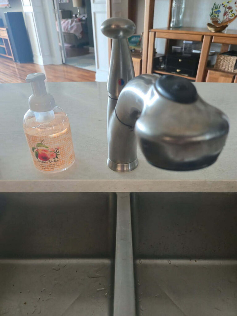 faucet installed on a kitchen sink with a soap dispenser beside it