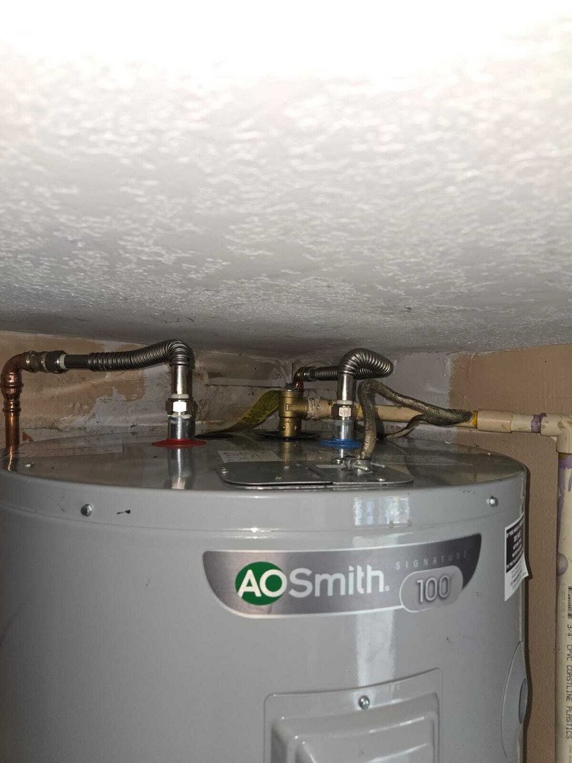 heating system installation with aao smith water heater and connected pipes and valves visible in a service area