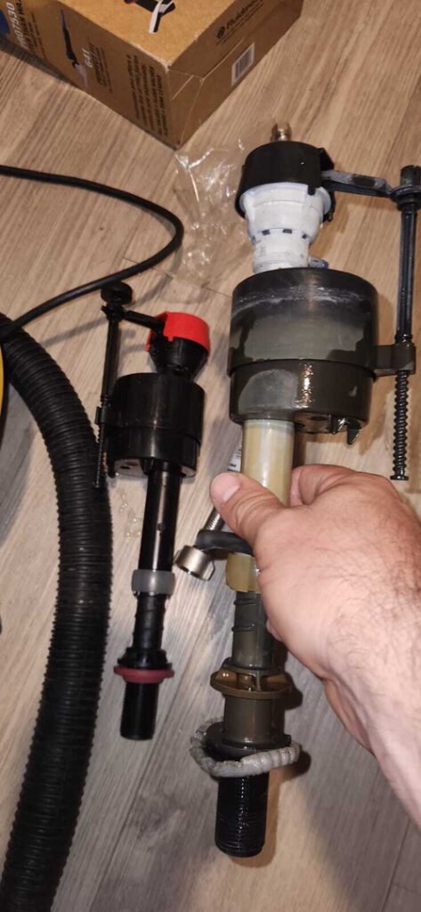 holding a fuel pump assembly with focus on components and connections for installation or repair on a flat surface