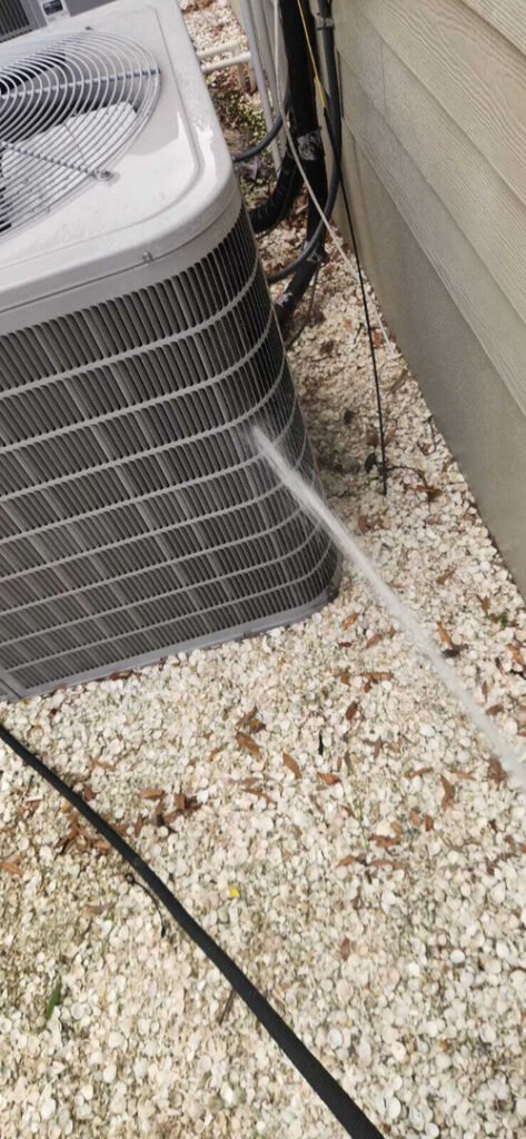 home therapist cooling heating and plumbing cleaning an outdoor air conditioning unit using a pressurized water nozzle