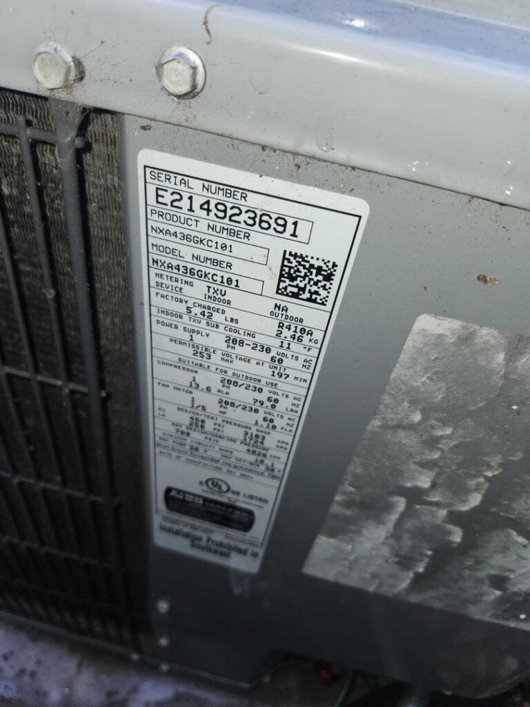 home therapist cooling heating and plumbing inspecting an outdoor ac unit checking serial and model information on the label
