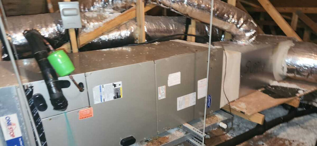 home therapist cooling heating and plumbing inspecting or servicing an hvac unit located in an attic space with ductwork present