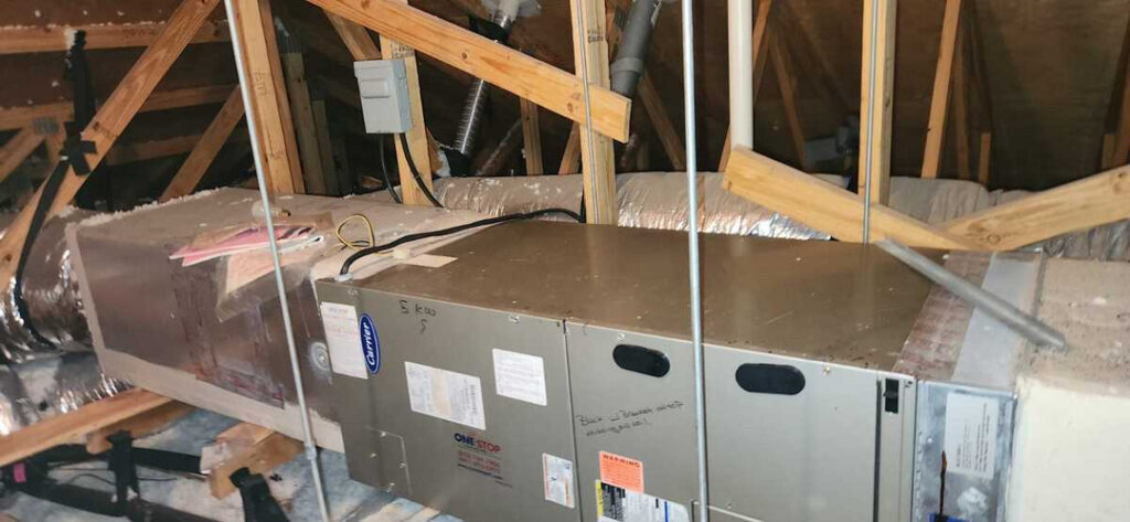 home therapist cooling heating and plumbing performing maintenance on an hvac unit in an attic space with wooden beams