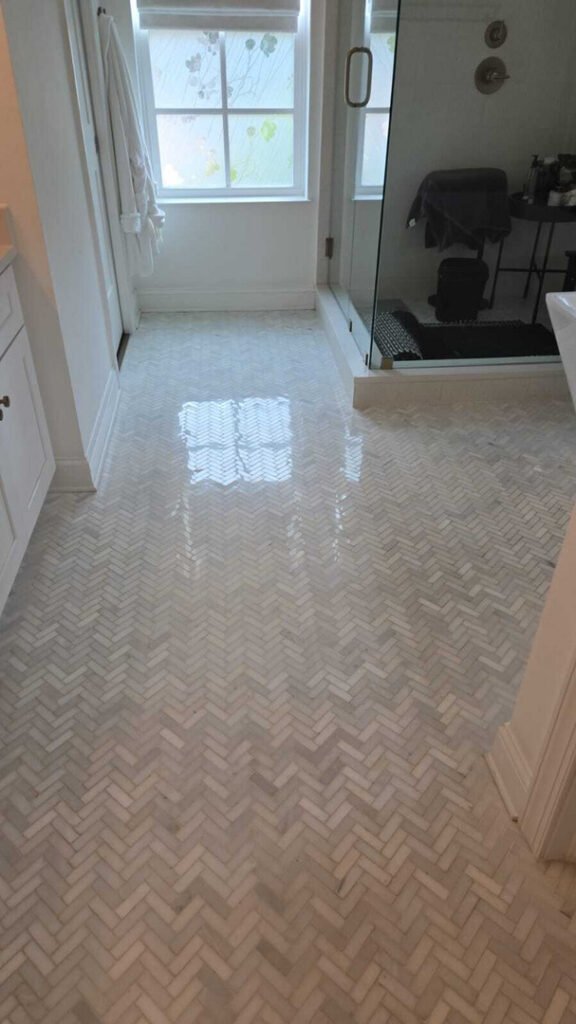 home therapist cooling heating and plumbing providing tile cleaning for a herringbone patterned floor in a bathroom setting