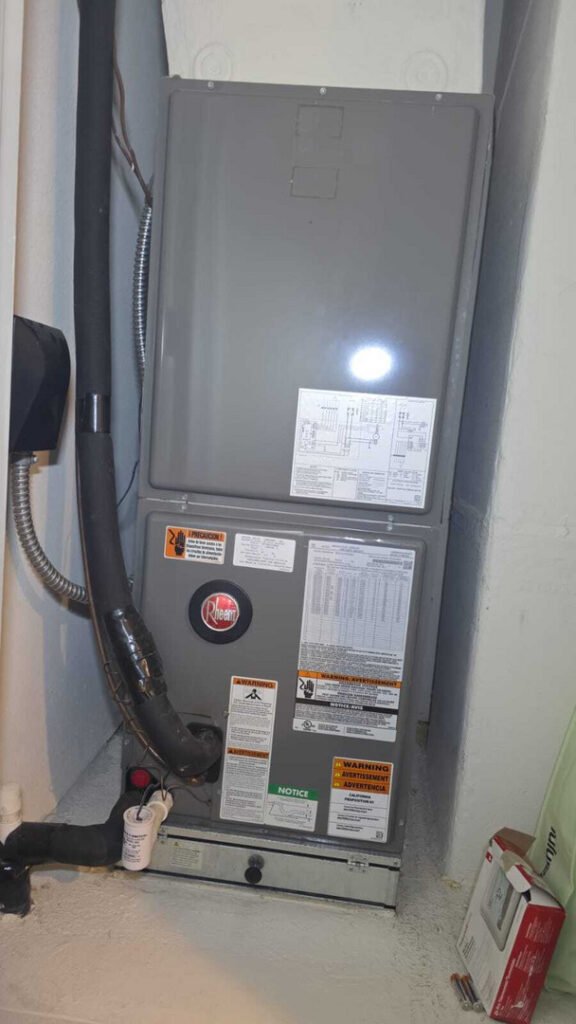 home therapist cooling heating and plumbing servicing a rheem furnace with multiple warnings and informational labels visible