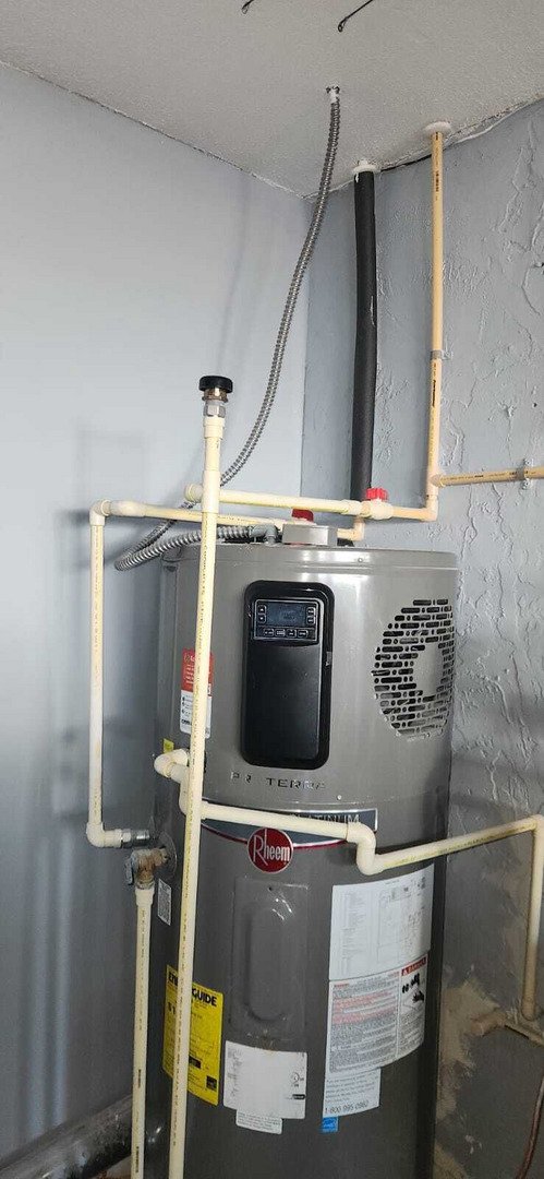 installation of a hot water heater with various pipes and connections in place for functionality and maintenance