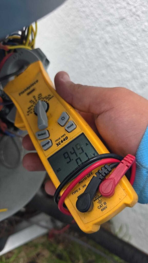 measuring electrical current with a multimeter as part of heating and cooling system diagnostics