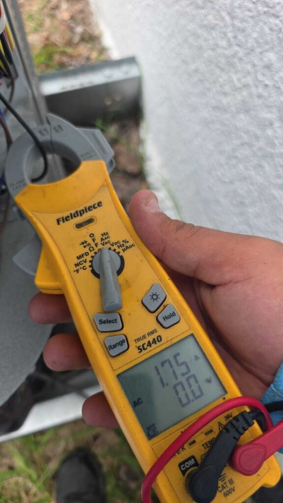 measuring electrical readings with a multimeter near heating or cooling equipment for diagnostic purposes