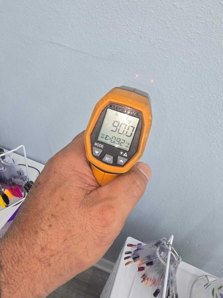 From one of our recent jobs: measuring surface temperature with a digital thermometer pointed at a wall in a residential setting.