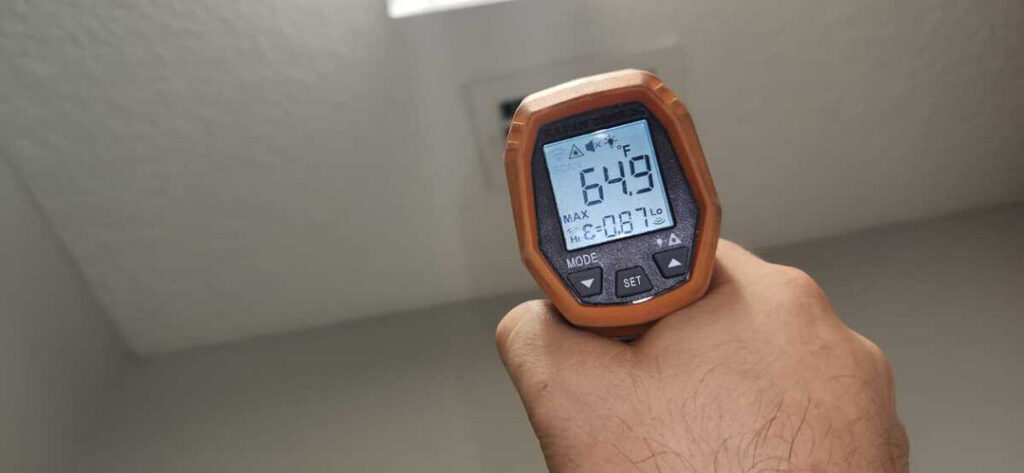 measuring temperature with an infrared thermometer indicating a reading of six hundred forty nine degrees fahrenheit
