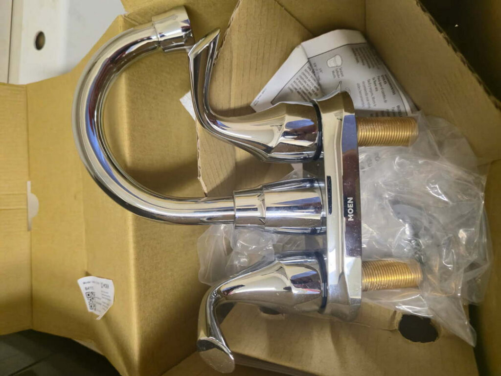 new chrome faucet assembly in packaging ready for installation with instruction manual included