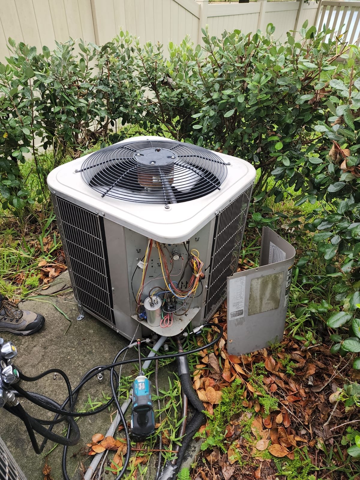 Outdoor Air Conditioning Unit With Wires And Leaves