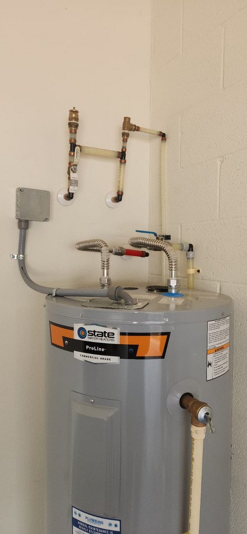 plumbing service involving installation or maintenance of a state proline commercial grade water heater with connected pipes and valves