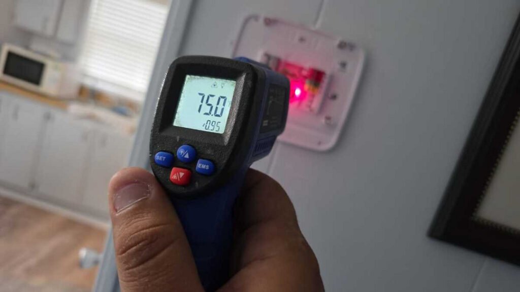 From one of our recent jobs: pointing an infrared thermometer to measure indoor temperature displaying seventy five degrees in a residential setting.