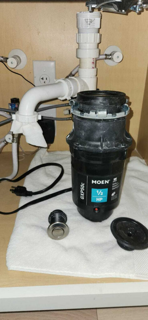 removal of a kitchen garbage disposal for maintenance or replacement with other plumbing components nearby