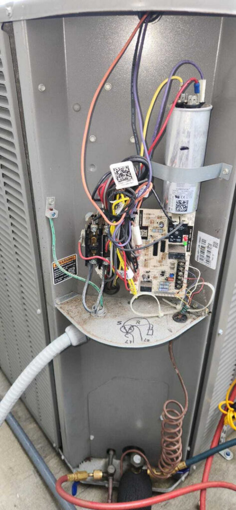repair service for an air conditioning unit focusing on electrical connections and wiring inside the unit