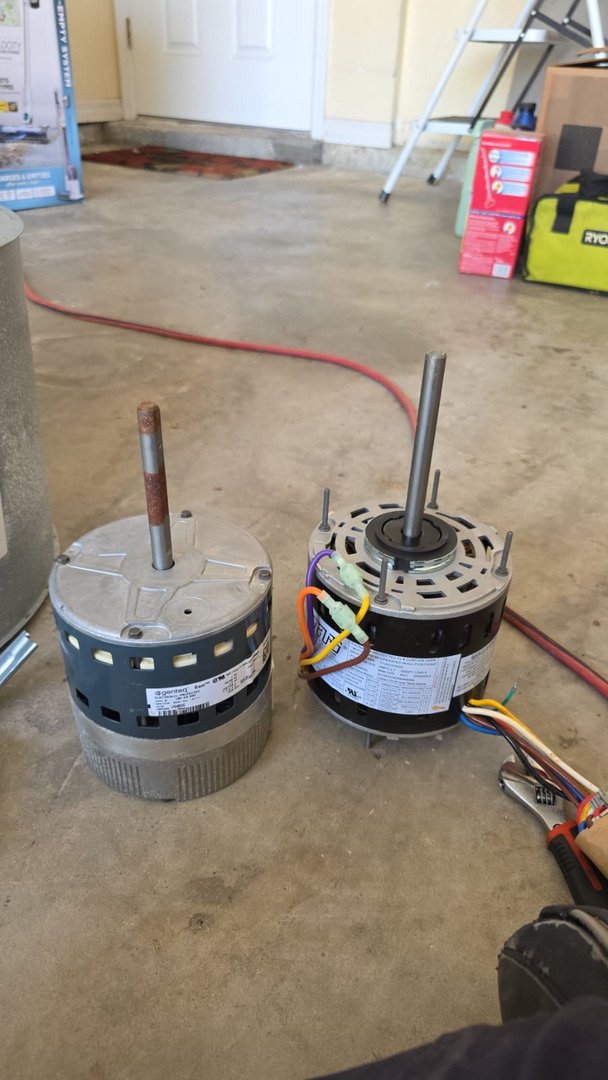 Replacing Electric Motors For Heating And Cooling Systems In A Garage Setting With Tools Visible In The Background