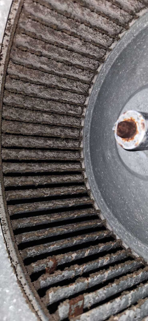 rusty blower wheel showing dirt debris buildup indicating potential maintenance or cleaning required for HVAC system