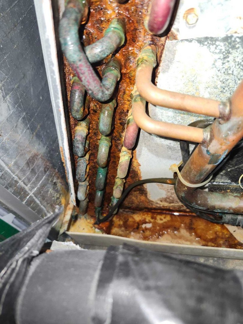 rusty pipes and corrosion visible indicating potential leak or maintenance issue in a heating or cooling system