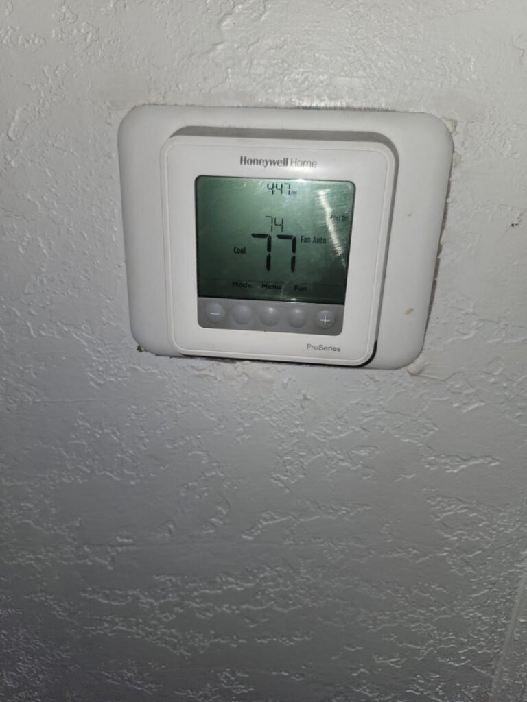 From one of our recent jobs: thermostat displaying current temperature and settings for heating and cooling system operation in a residential setting.