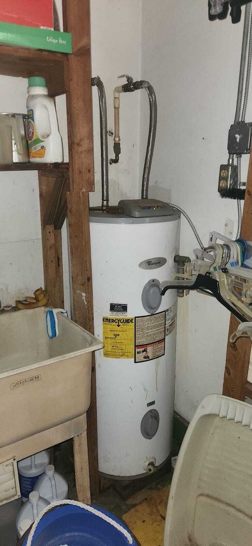 water heater repair or installation in a utility area with additional plumbing tools and supplies nearby