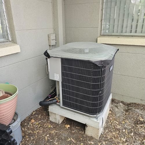 Outdoor Air Conditioning Unit In Residential Area With Plants
