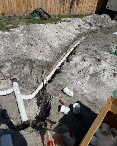 home therapist cooling heating and plumbing installing pvc pipes in a trench for drainage or plumbing purposes